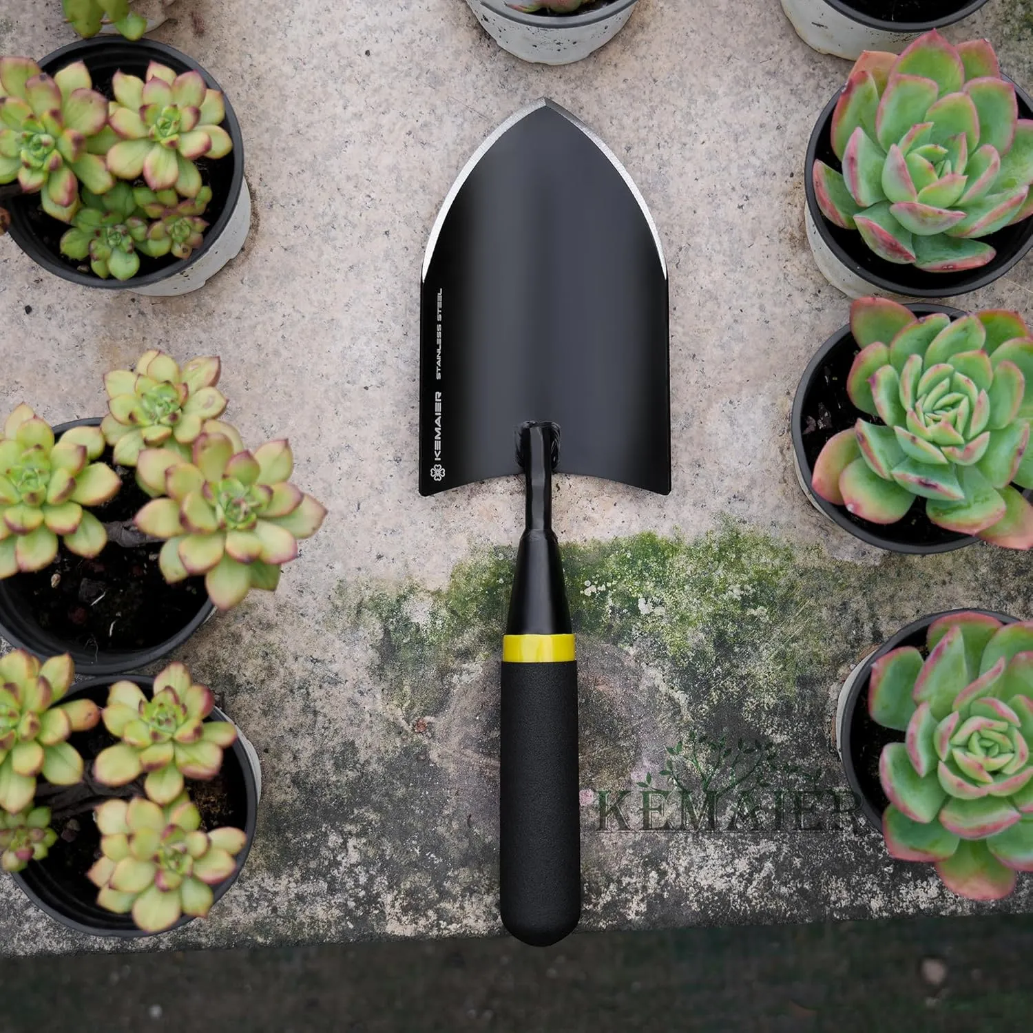 A hand trowel resting in a large patio planter